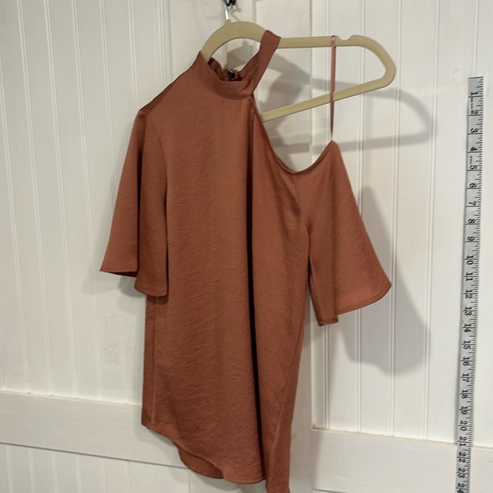 Express cold shoulder silky, copper color top with back zipper. Size XXS